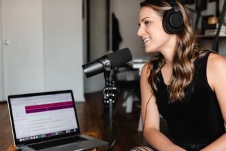 Person dictating into a microphone while text appears on a laptop, testing a Wispr Flow alternative